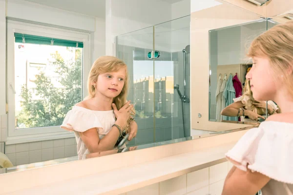 Morning routine in the bathroom while brushing long hair — Stock Photo, Image