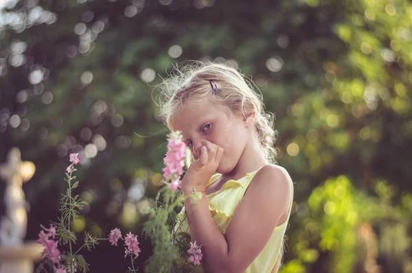romantic child with pink flowers portrait