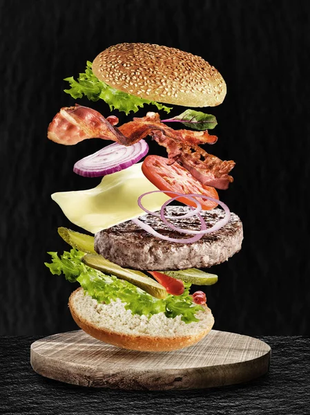 fast food burger ingredients, beef meat, tomatoes, cheese, salad, buns, onion, cucumbers