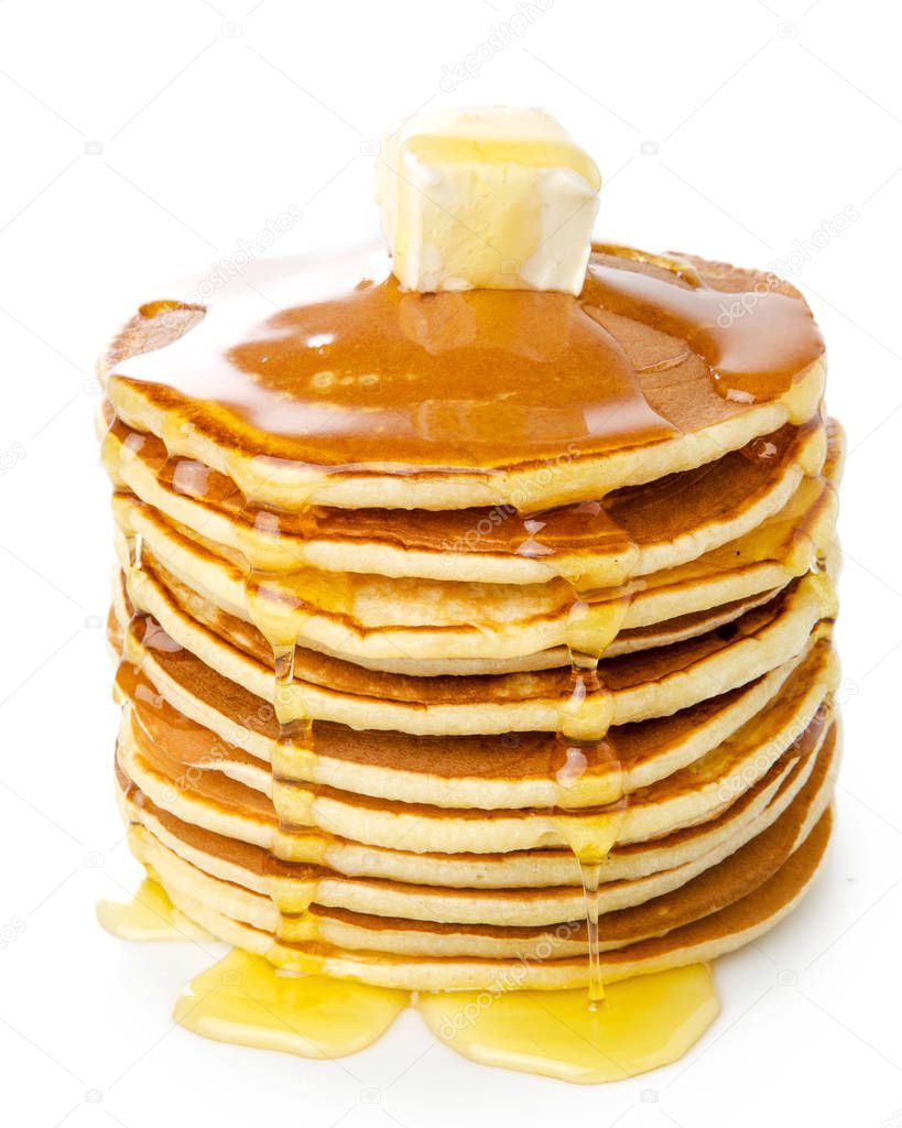 stack of brown pancakes with butter on top and maple syrup