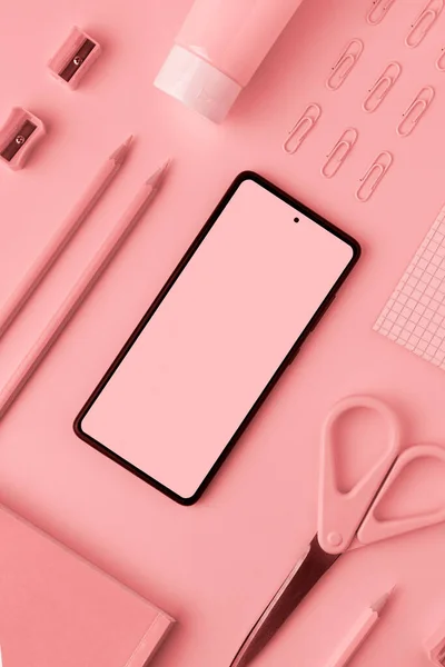 Pink smartphone mockup, pencils, paper clips, scissors, pencil sharpeners — Stock Photo, Image