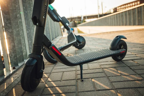 Kiralık elektrikli scooter şehir sokaklarında park, Çevre dostu ulaşım.
