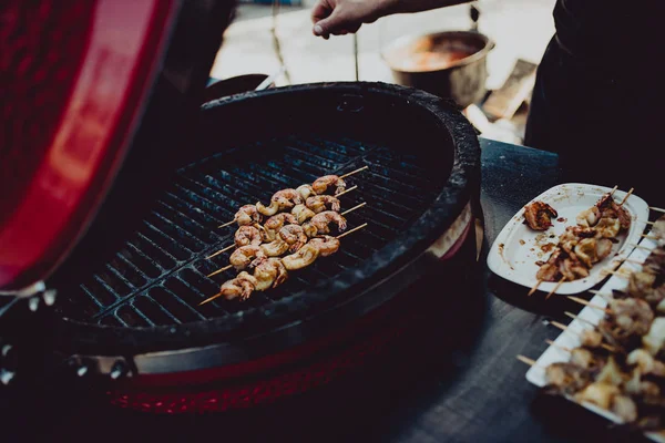 Street food festival, cooks preparing food in outdoor market