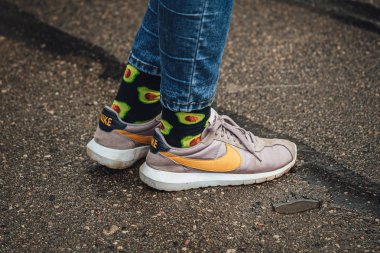 man wearing colorful socks standing on the street