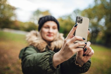 Riga, Latvia september 23, 2019 Woman using iphone 11 pro for photography, triple smartphone camera in close up