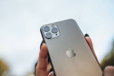Riga, Latvia september 23, 2019 Woman using iphone 11 pro for photography, triple smartphone camera in close up