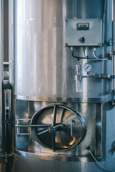 Craft beer brewing equipment in brewery! Metal tanks, alcoholic drink production