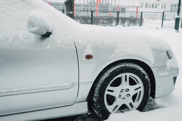 Driving in winter, Car wheel on snowy road. Winter season
