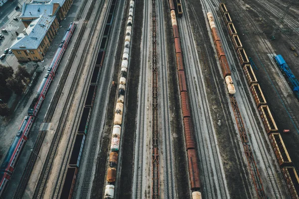 Cargo trains close-up. Aerial view of colorful freight trains on the railway station. Industrial conceptual scene with trains. Top view from flying drone
