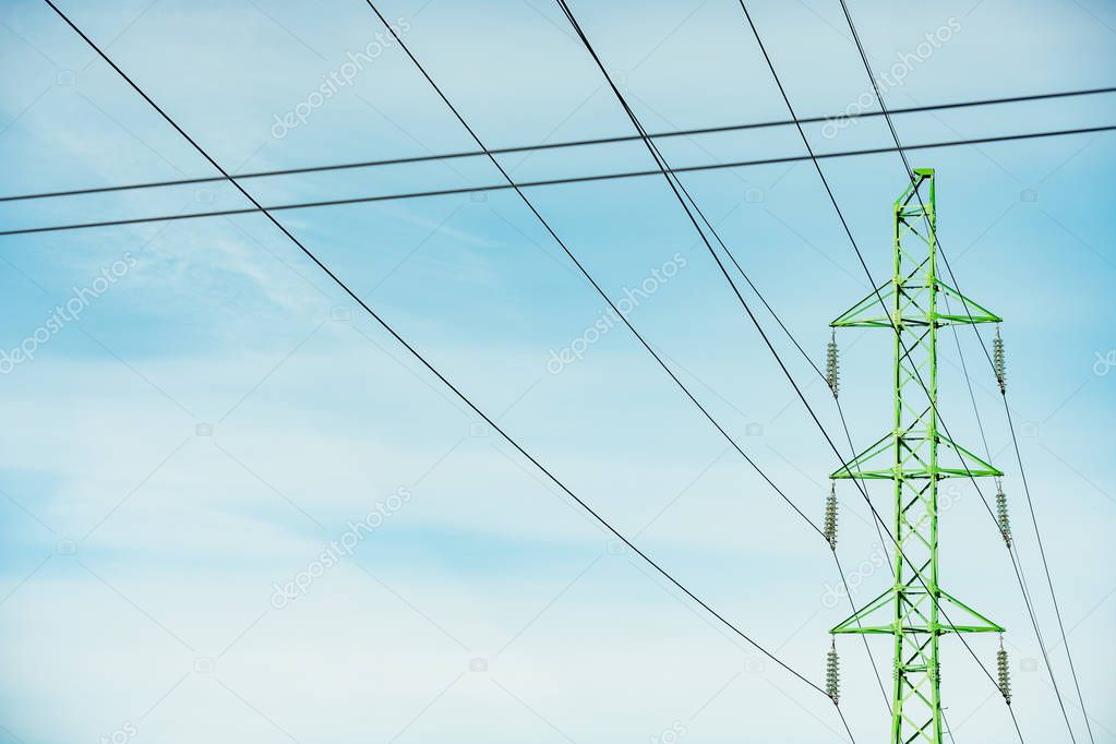 High-voltage tower in green color, electricity supply 