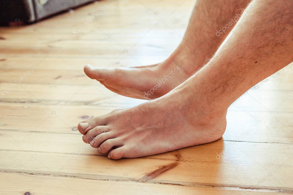 Man sleeping in the bad, man feet in close up view 