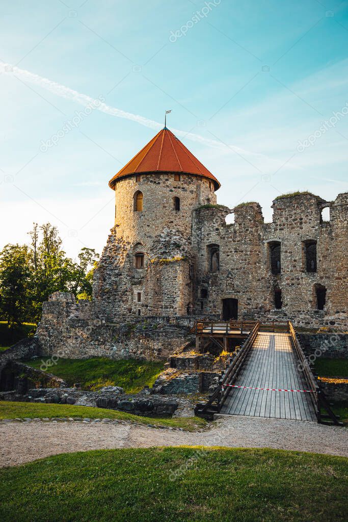 View on beautiful ruins of ancient Livonian castle in old town of Cesis, Latvia, warm sunset time.