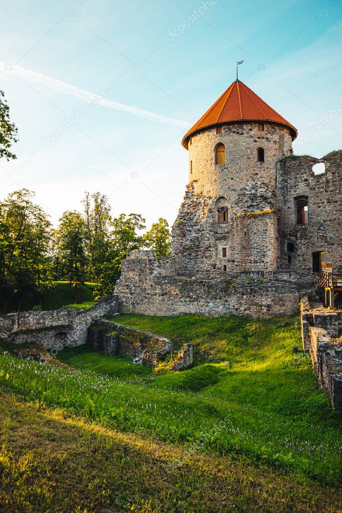 View on beautiful ruins of ancient Livonian castle in old town of Cesis, Latvia, warm sunset time.