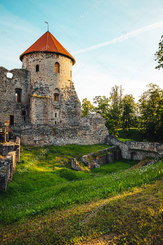 View on beautiful ruins of ancient Livonian castle in old town of Cesis, Latvia, warm sunset time.