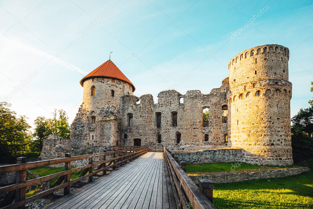 View on beautiful ruins of ancient Livonian castle in old town of Cesis, Latvia, warm sunset time.