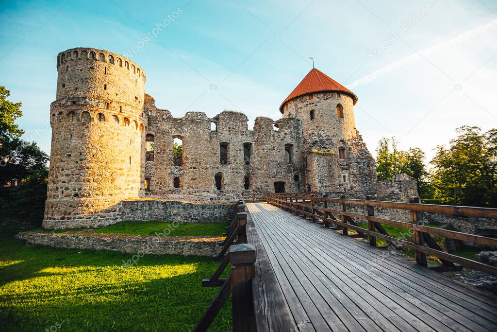 View on beautiful ruins of ancient Livonian castle in old town of Cesis, Latvia, warm sunset time.