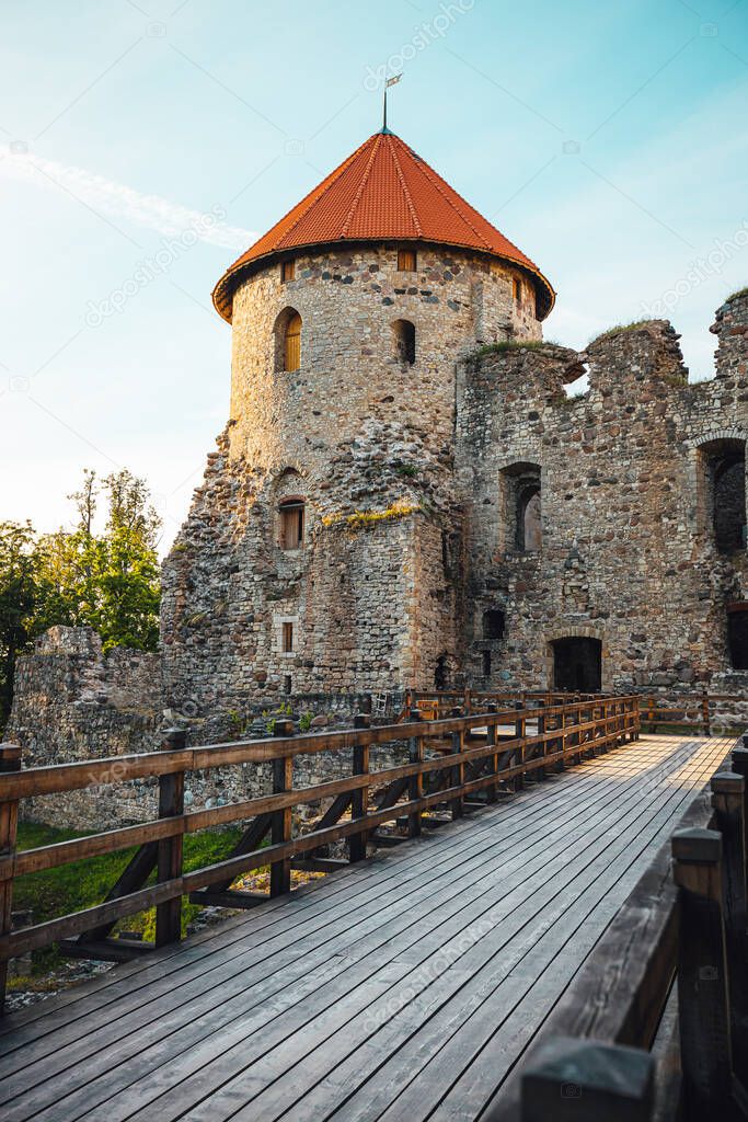 View on beautiful ruins of ancient Livonian castle in old town of Cesis, Latvia, warm sunset time.