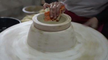 hands working clay on potter's wheel, Lampang in Thailand