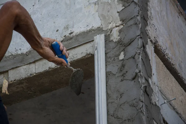 Plasterer Concrete Worker At Wall Of House Construction