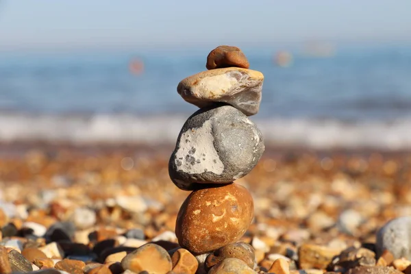 Balancing stones on the beach