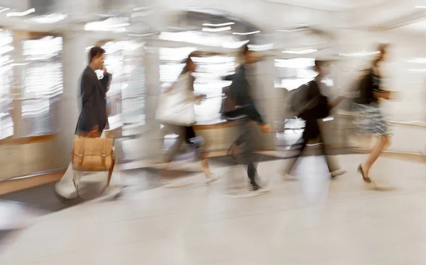 abstract image of people in the lobby of a modern business center with a blurred background