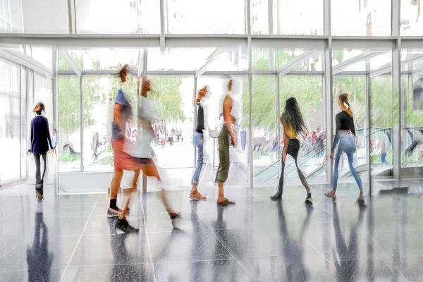 abstract image of people in the lobby of a modern business center with a blurred background