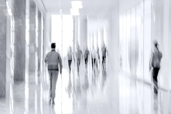 abstract image of people in the lobby of a modern business center with a blurred background