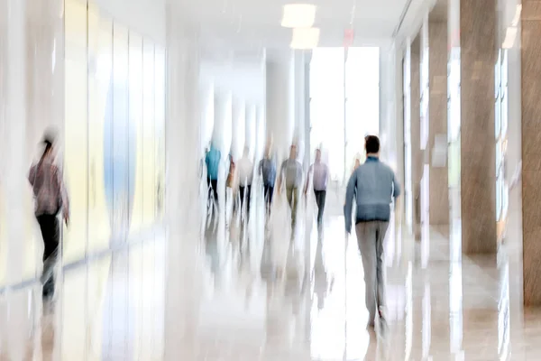 abstract image of people in the lobby of a modern business center with a blurred background