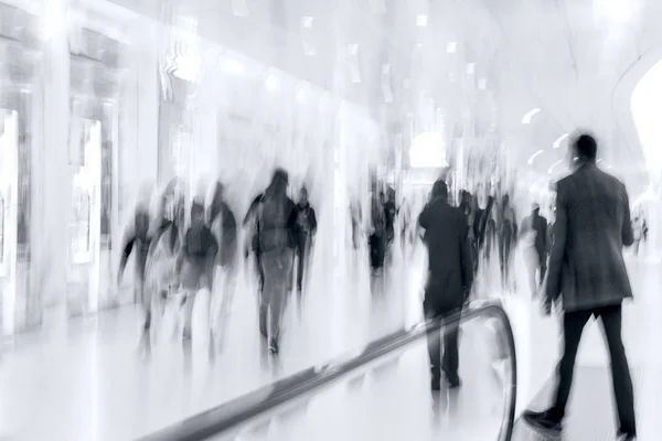 Group of people in the lobby business center in monochrome blue — Stock Photo, Image