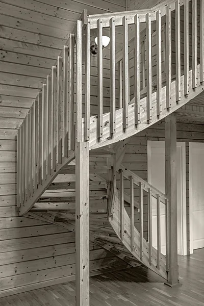 internal wooden spiral staircase in a yellow monochrome tonality