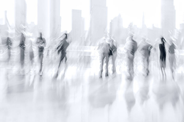 abstract image of people in the lobby of a modern business center with a blurred background