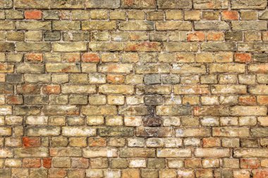 Eski sarı tuğla duvarın arka planı