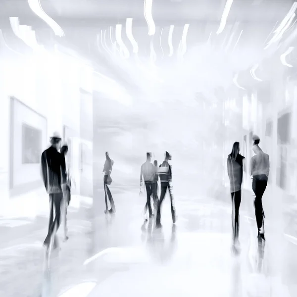 abstract image of people in the lobby of a modern art center with a blurred background