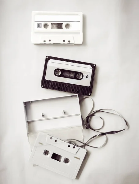 High-key lighting of black and white vintage tape cassette recorder, flat lay, top view. retro technology