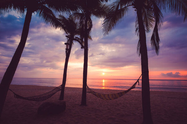 Silhouette of tropical beach during sunset twilight. seascape of summer beach and palm tree at sunset. vintage color tone