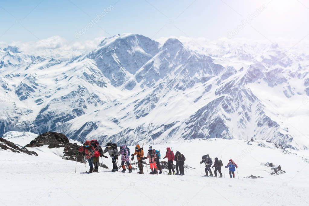 A group of climbers walking high in the mountains.