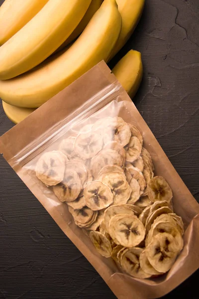packing fruit banana chips next to fresh bananas