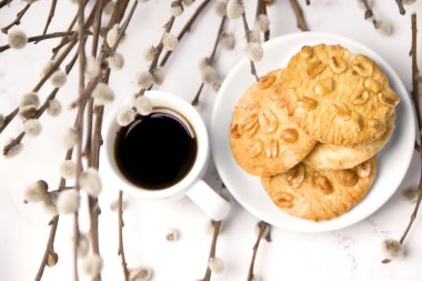 Bahar kahvaltısı. Hafif kahvaltı. Fıstıklı kurabiyeli kahve. Beyaz arka planda kahvaltı. Söğüt dalları