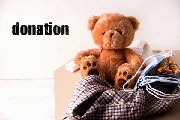 Concept donation of volunteers of things and toys with medicines on a white background