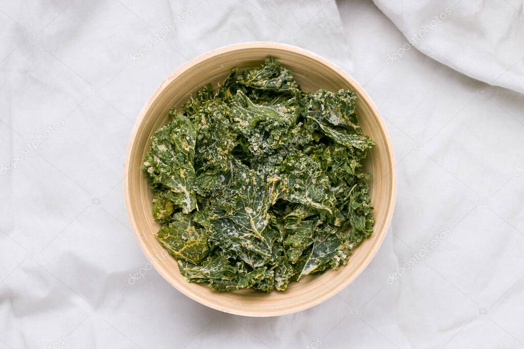 Kale chips on a gray background. View from above