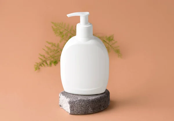 Mockup of a cosmetic product on a gray stone. beige background