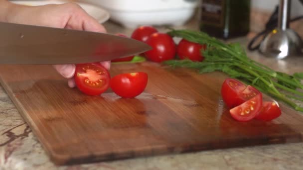 Faca de cozinha cortar tomates frescos cereja na tábua de madeira. Cozinhar alimentos saudáveis — Vídeo de Stock