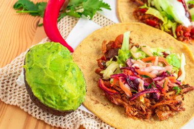 Mexican traditional authentic homemade tacos with pulled pork beef chili con carne serve with tomato salad and avocado guacamole and dip sauce clipart
