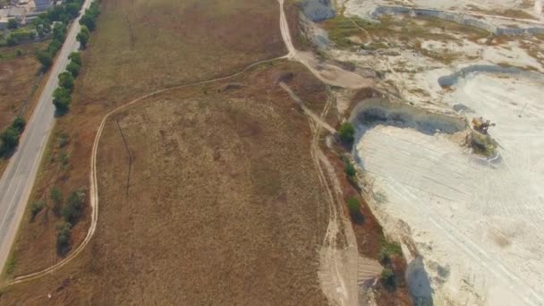 Quadrocopter vuela sobre campo y cantera — Vídeos de Stock