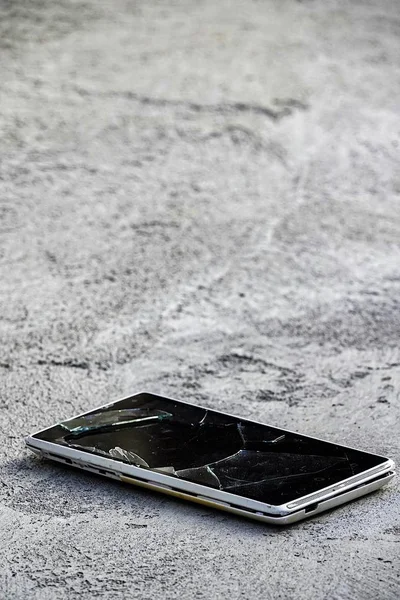 The smartphone fell on the ground of the accident Broken glass broken screen communication insurance