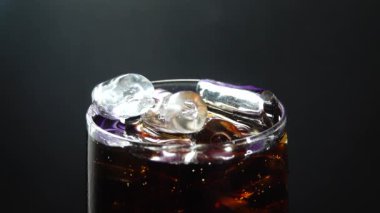 4K, bir bardağı Coca ile dolduruyor. Gazozda baloncuklar, kırmızı destansı, bardaktan aşağı akan su damlaları, cızırdayan köpük, buzlu bardak.