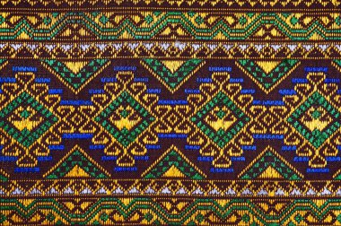 100 yıldan daha eski renkli Tayland el sanatları Peru tarzı halı yüzeyi. Doğal malzemelerden yapılmış eski, yırtık, kimyasal malzemelerden yapılmış. Yakın çekim..