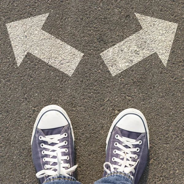 Coppia Scarpe Piedi Una Strada Con Tre Frecce Bianche Sul — Foto Stock