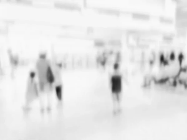 Blurred people walking at hallway in airport for background usage