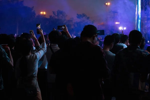 Hand with a smartphone records live music festival, Taking photo of concert stage, live concert, music festival